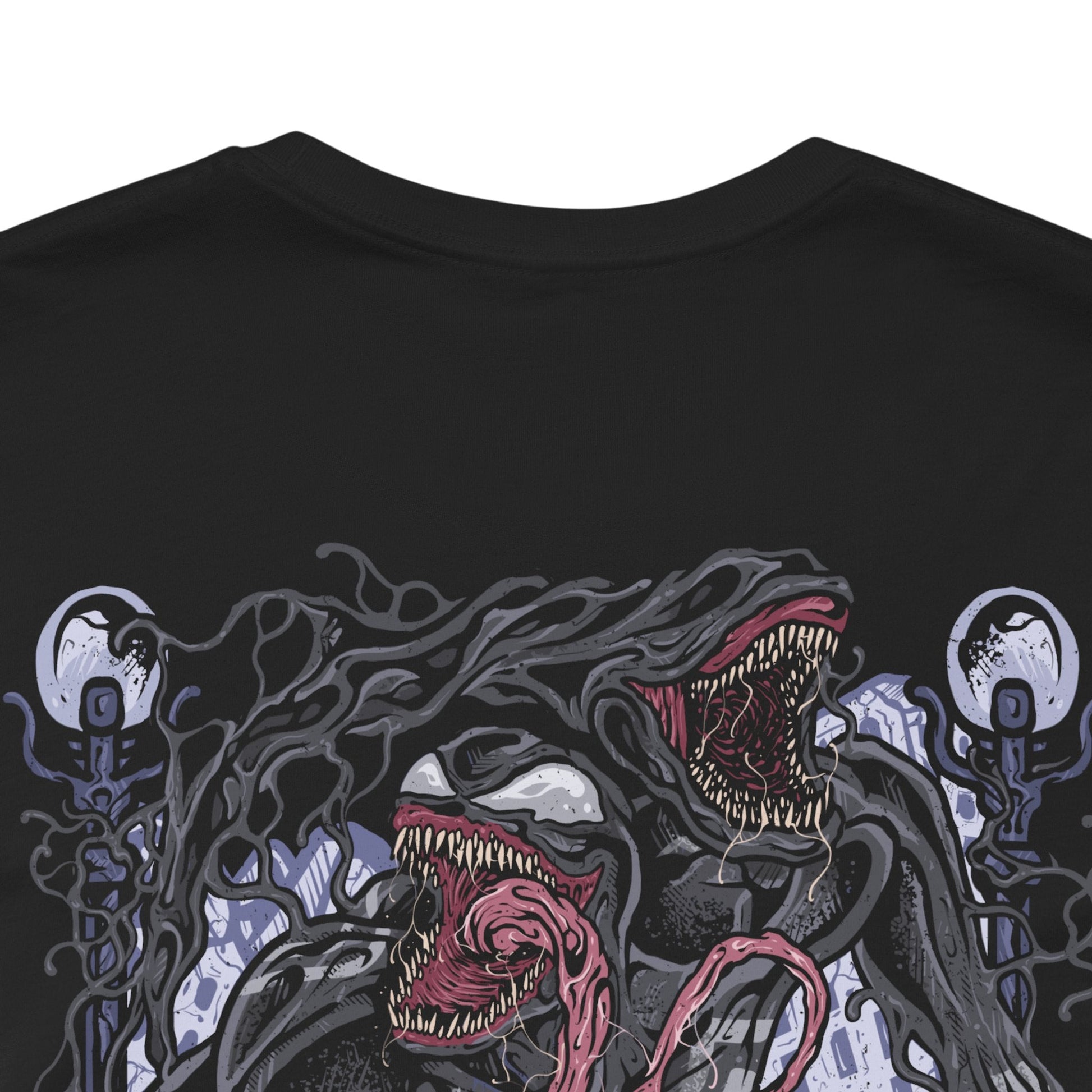 Image 7 of a T-Shirt artwork depicting Venom lunging from the shadows with claws extended, black symbiote tendrils whipping through the air around him. Rain falls across a dark city skyline while his white spider emblem glows against the living suit. This design reflects raw aggression, chaotic strength, and the relentless hunger that makes Venom one of Marvel’s most iconic antiheroes.